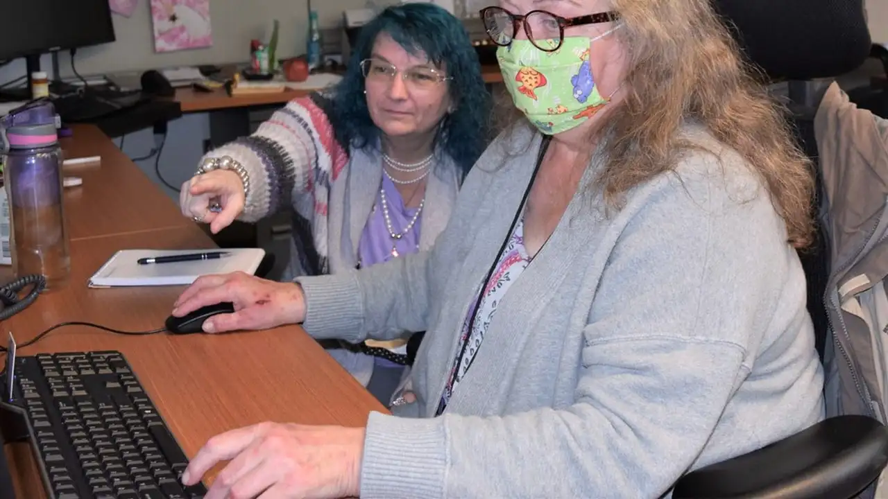 Independent insurance agent reviewing a Florida homeowners policy with clients at an office desk